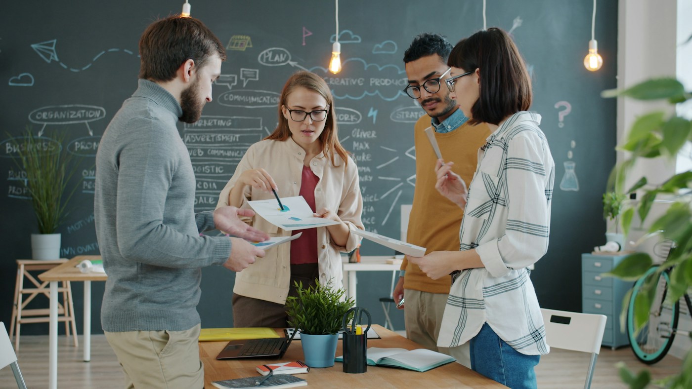 A team exchanging ideas around a desk